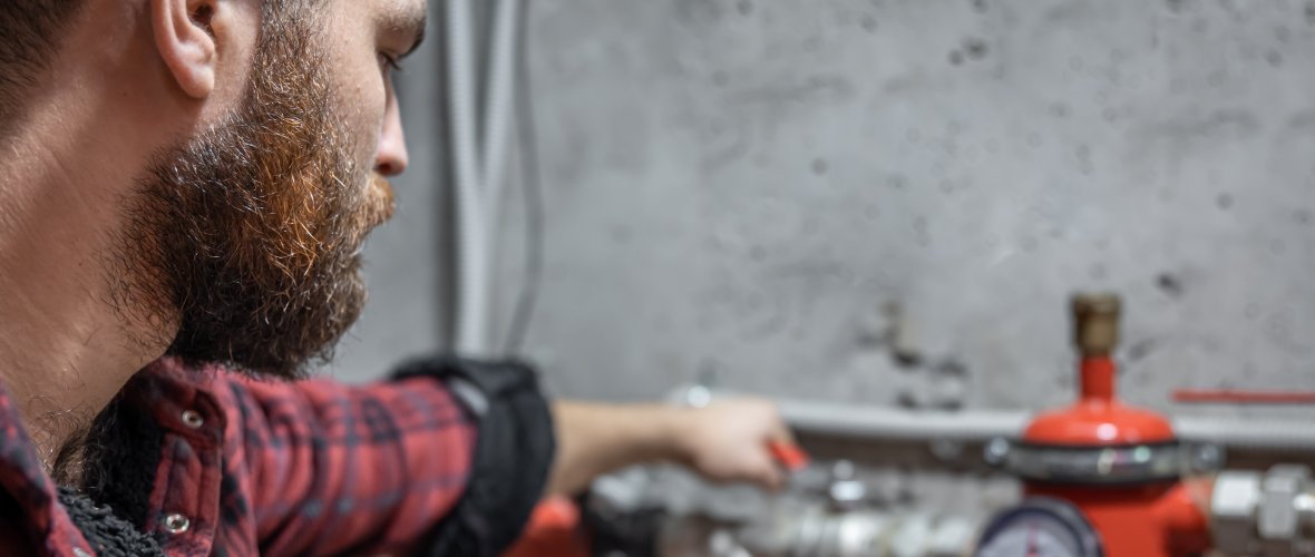 Handwerker und Leitungen Mann schaut sich Leitungen an